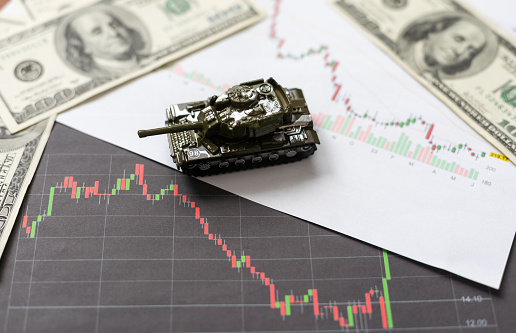 Businessman on a tanks with confidence and diagrams rising stock. High quality photo