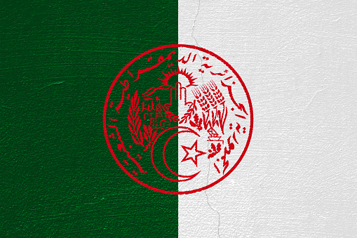 Flag and coat of arms of the Algerian People's Democratic Republic on a textured background. Concept collage.