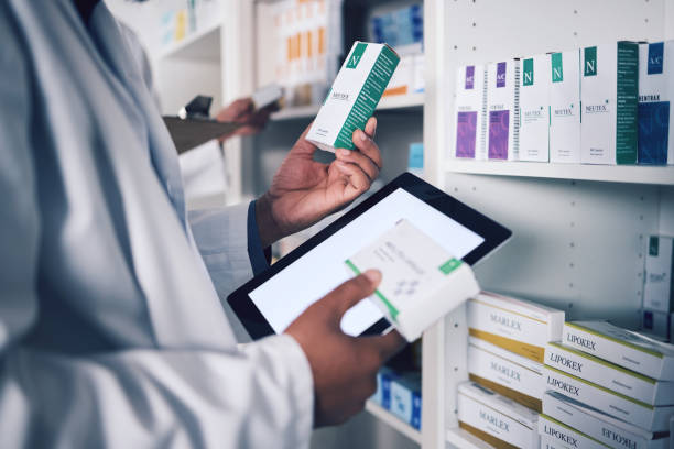 istock Pharmacist, tablet and hands for inventory inspection, box or medication on shelf at the pharmacy. Man, medical or healthcare professional checking stock, pills or medicine for storage at drugstore 1627656424
