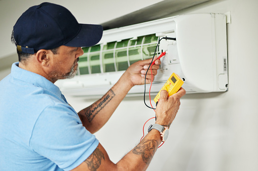 Air conditioner, meter and electrician man for ac repair, maintenance and electrical power services on fan system. Person, technician or contractor with electricity, box check and hvac engineering