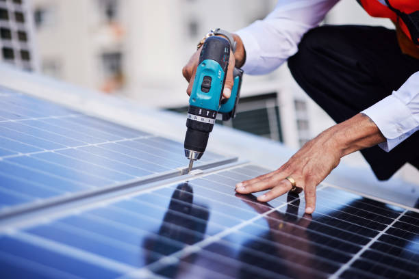 istock Solar panels, person hands and tools for engineering maintenance, electrical repair and rooftop contractor, Grid, drill and industrial worker or electrician for eco photovoltaic installation in city 1627686761