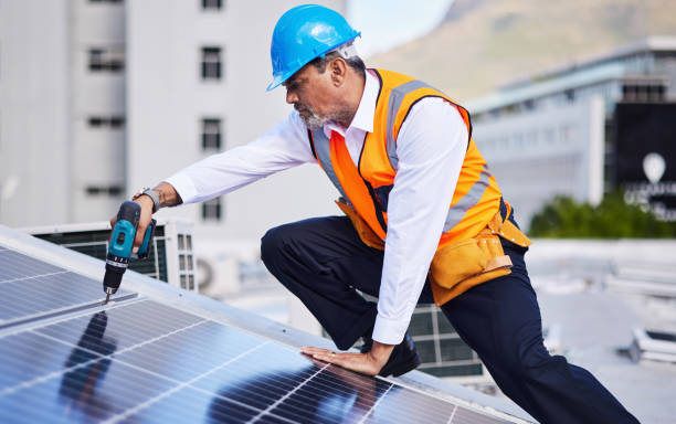 istock Solar panels, man and power drill for engineering, grid and building maintenance in city. Electrician, construction tools and inspection of energy saving electricity, photovoltaic system and rooftop 1627691094