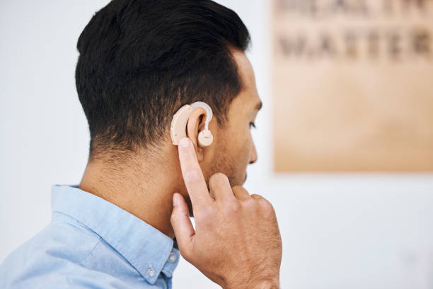 istock Hearing aid, deaf and man with ear disability with medical support device as wellness innovation or audiology implant. Patient, auditory and male person with an amplifier for help listening 1627701408