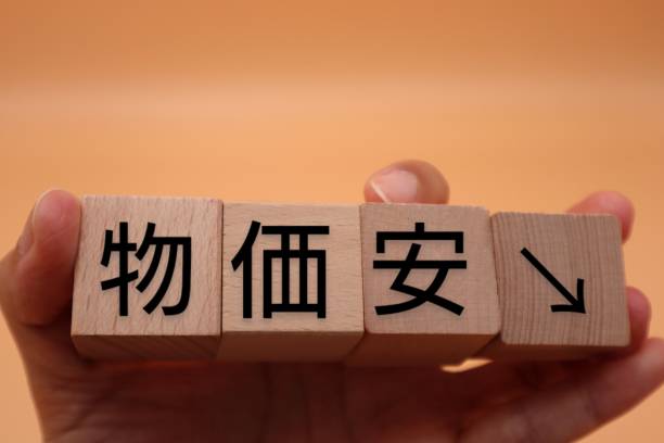 istock A person holding a building block with low prices written on it 1627727720