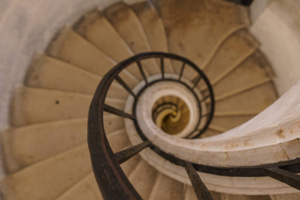 istock Beautiful old dilapidated spiral staircase with a metal railing destroyed. 1627730333