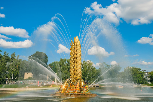 Moscow, Russia - August 10, 2023: Fountain Zolotoy Kolos (Golden spike) on the territory of the All-Russian exhibition center (VDNH)