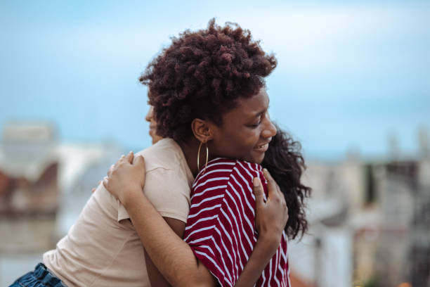 You are my love and support Two young women hugging each other on the top of a building in the city mercy hug stock pictures, royalty-free photos & images