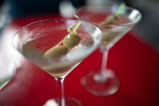 martini cocktail with stuffed olive and measure
