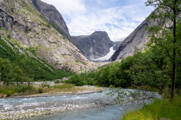 istock Brendalsbreen glacier and crystal clear river in the front 1627785520