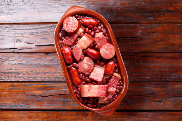 istock brazilian feijoada in ceramic bowl isolated on rustic wooden background. Copy space 1627808487