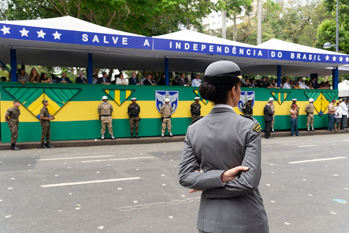 Katwa WB India - January 26, 2021 : Taken this picture in the town of Katwa in state of West Bengal on Republic Day Morning. In the picture police saluting to District Magistrate who hoisted the Indian Flag on school ground. In background are spectators witnessing the flag hoisting sitting on the top of the school building.