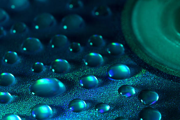 water drops on the surface of a CD with a beautiful reflection , abstract photography , macro photography