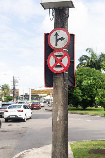 Salvador, Bahia, Brazil - August 11, 2023: A traffic sign indicating that it is forbidden to stop and park and another one that indicates to go ahead and turn right. city of Salvador, Bahia.