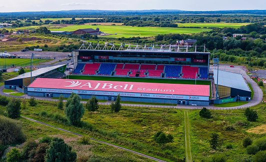 Aerial shot of AJ Bell rugby Stadium on the side of a river.