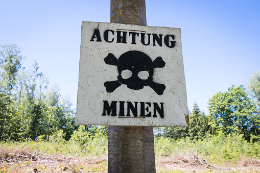 Warning of mines. Danger of explosion. Line of defense. Military base. German inscription: Danger mines