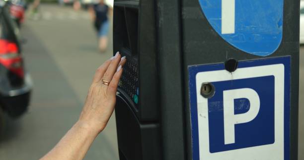 istock Closeup elegant female hand type license plate number on parking meter keypad 1627882602