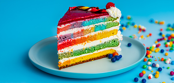 Colorful multicolored cake with icing and candies for design purpose
