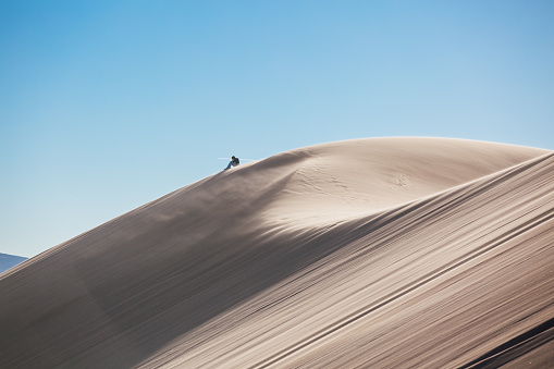 Lonely traveler, travel blogger walking alone in the Sahara desert, hot temperatures, desert life.