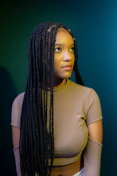 istock Young woman with braids, serious. 1627953336