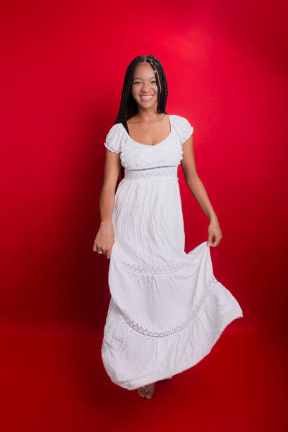 istock Beautiful young woman, standing, in long white clothes. 1627953921