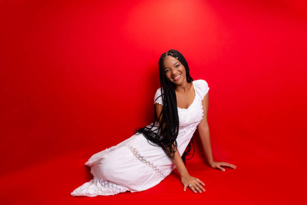 istock Beautiful young black woman sitting down smiling at the camera. 1627954234