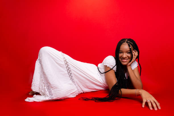 istock Beautiful young black woman sitting down smiling at the camera. 1627954454