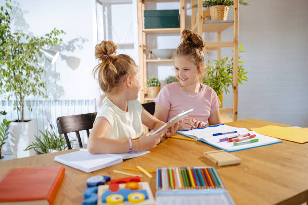 istock Playful little girls having fun at home 1627963433