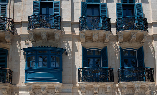 Detail of the facade of the historic Vincenzo Buceia Conservatory in Malta. You can see the typical blue balconies