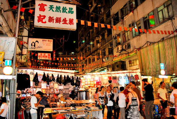 Temple Street is situated in the areas of Jordan and Yau Ma Tei in Kowloon, Hong Kong. It is best known for its night market, which is popular with tourists and locals alike. The market typically sells cheap merchandise, but it also has restaurants and food items. This nighttime photograph was captured during September of 2010.