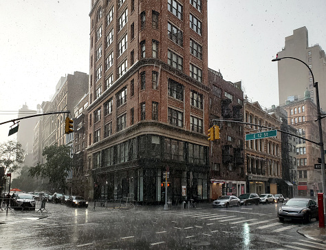 Summer thunderstorm raining on the intersection of Broadway and 12th Street in New York City NYC