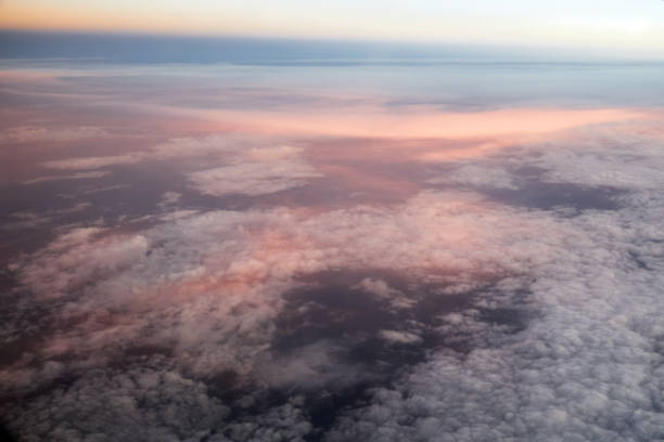 istock Pink clouds under the wing of an airplane. 1628068042