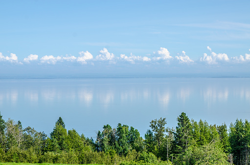 Clouds reflecting in St. Lawrence river during summer day