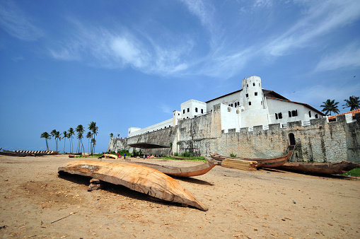 Elmina, Ghana: crenulated ramparts of São Jorge da Mina Castle, also known as Mina or Feitoria da Mina, built by Portugal in 1482. First established as a trade settlement, the castle later became one of the most important stops on the route of the Atlantic slave trade. The Dutch West India Company seized the fort from the Portuguese in 1637, and took over all of the Portuguese Gold Coast in 1642. The slave trade operated under the Dutch until 1814. In 1872, the Dutch Gold Coast, including the fort, became a British possession - colonial architecture - UNESCO World Heritage Site.