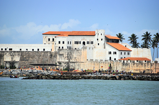 Elmina, Ghana: São Jorge da Mina Castle, also known simply as Mina or 'Feitoria da Mina'. The foundation stone for the fortress was laid on January 21, 1482 by the Portuguese seafarer Diogo de Azambuja, who commanded a fleet of nine ships, around 600 sailors and soldiers and around 100 craftsmen and servants on behalf of the Portuguese King John II. First established as a trade settlement, the castle later became one of the most important stops on the route of the Atlantic slave trade. The Dutch seized the fort from the Portuguese in 1637, and took over all of the Portuguese Gold Coast in 1642. The slave trade operated under the Dutch until 1814. In 1872, the Dutch Gold Coast, including the castle, became a British possession - colonial architecture - UNESCO World Heritage Site.
