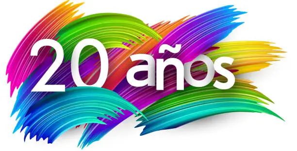 Vector illustration of 20 years at spanish paper word sign with colorful spectrum paint brush strokes over white.