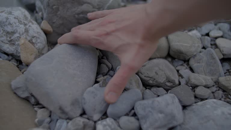 Sand Stones Falling Into Hands of a Person in Slow Motion Outdoors in Nature Environment