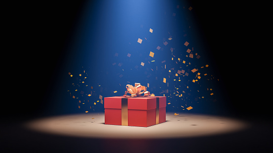 A red gift box with a gold tone ribbon and colored paper with spotlights, 3d rendering