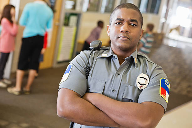 istock Police officer patrolling hallway in elementary school 162817308