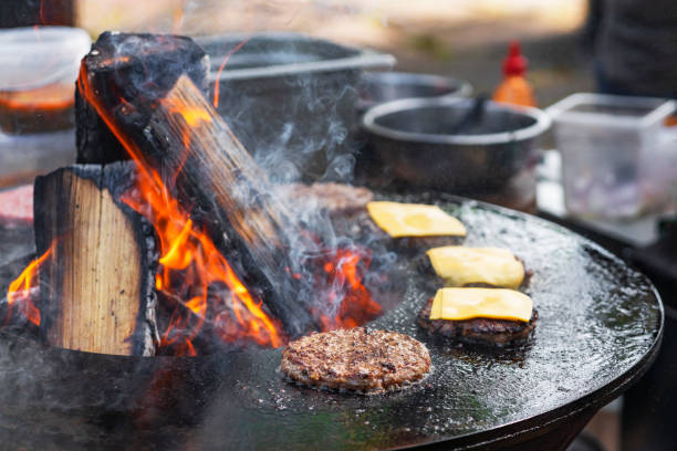 istock Cooking Burgers on a hot Grill with a flame 1628199750