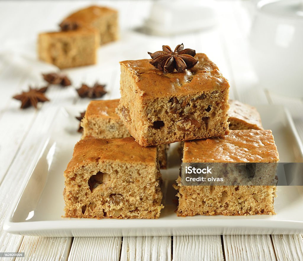 Pieces of cake on a white plate Pieces of cake decorated with star anise on a white plate and white table Baked Pastry Item Stock Photo