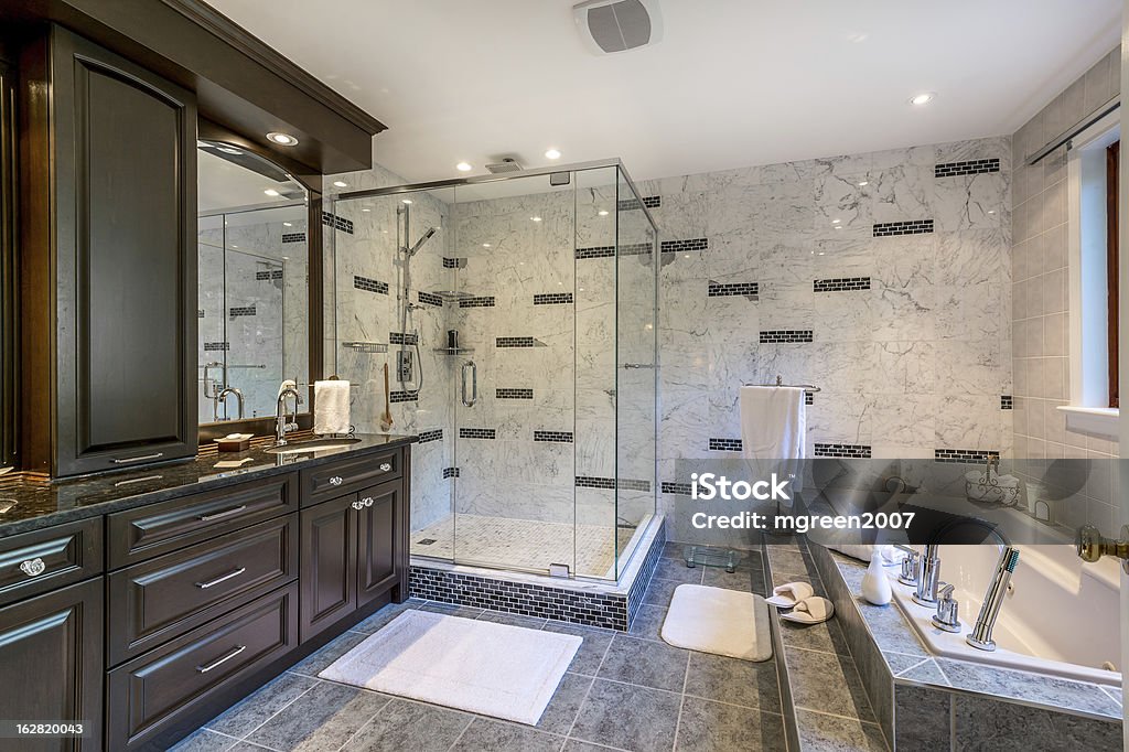 Luxury Bathroom Elegant bathroom with Tub and plexiglass shower. Bathroom Stock Photo
