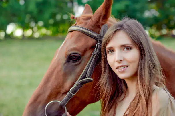 Close up portrait of a woman and horse in rural landscape. Equestrianism promotes well-being and stress relief. Hippotherapy, animals help with stress, a gift certificate for emotions