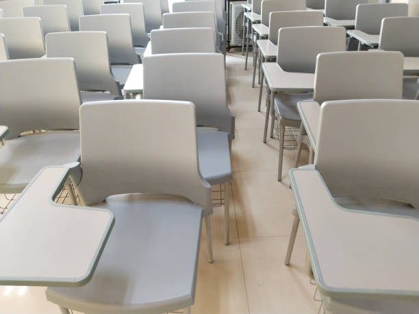 istock Lecture room or School empty classroom with painted chair iron wood for studying lessons in high school, interior of secondary education, vintage tone educational concept 1628218466