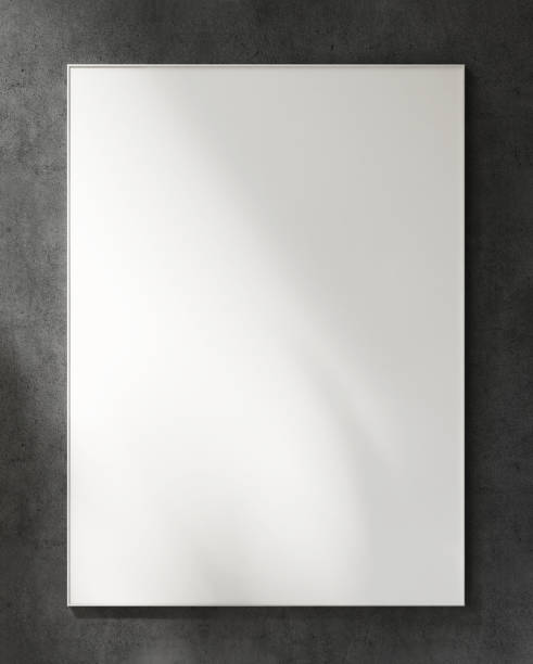 istock Blank large white photo poster wooden frame on black concrete wall in sunlight, leaf shadow 1628218695