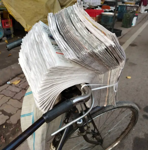 Photo of newspaper for sale, distrubing news paper with cycle