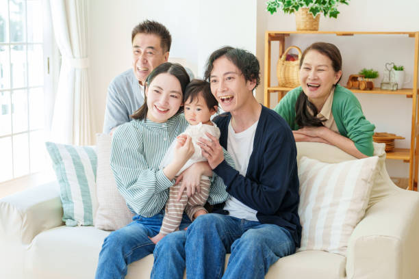 istock three generations asian family relaxing on sofa 1628267335