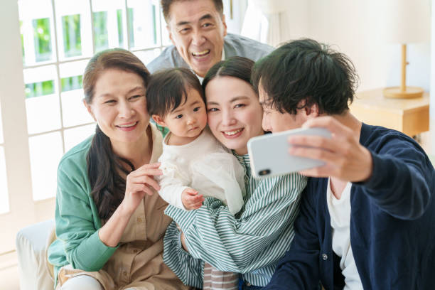 three generations asian family taking selfie