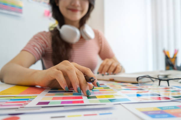 istock Interior designer working with color samples, choosing colorful paper charts at desk. 1628271588