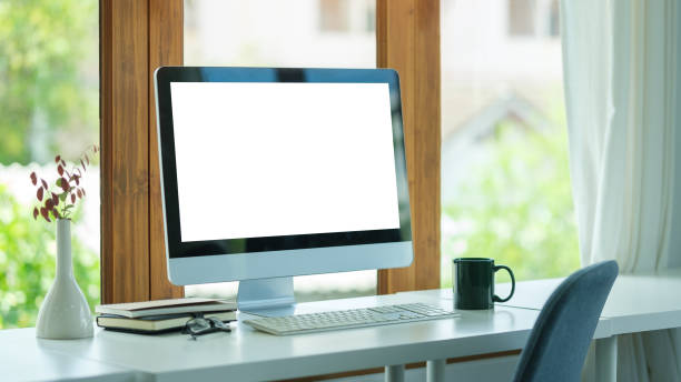 istock Comfortable home office. Computer, stationery and potted plant on white table. 1628280375