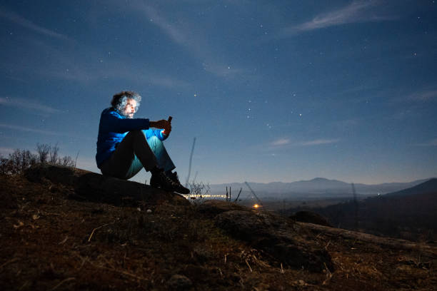 istock People in nature. Man with phone at high viewpoint. 1628283548